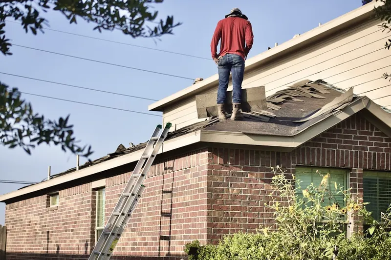 Professional roofer working on a residential roof in Hasbrouck Heights